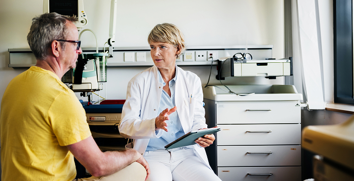 Doctor consulting with a patient about cancer treatment options, highlighting the impact of cancer research in healthcare.